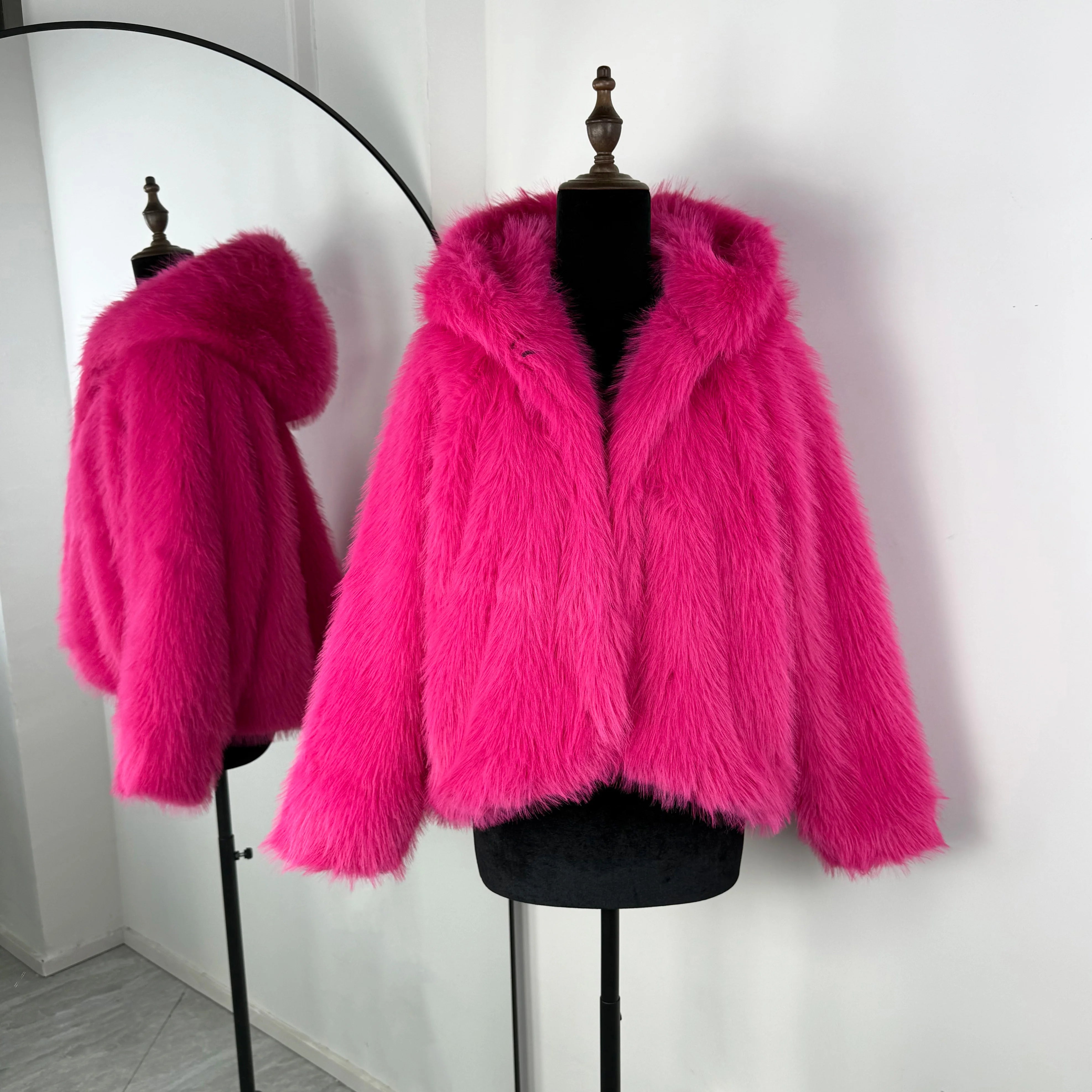 Hot pink fur coat on a mannequin against a white background